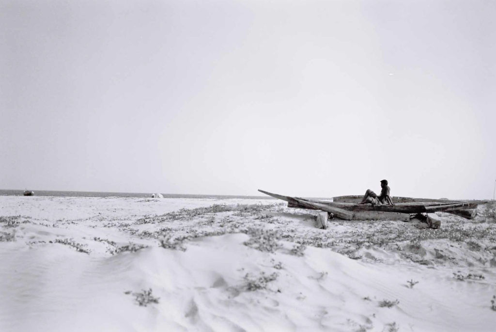 Distant figure on a pale rocky ridge