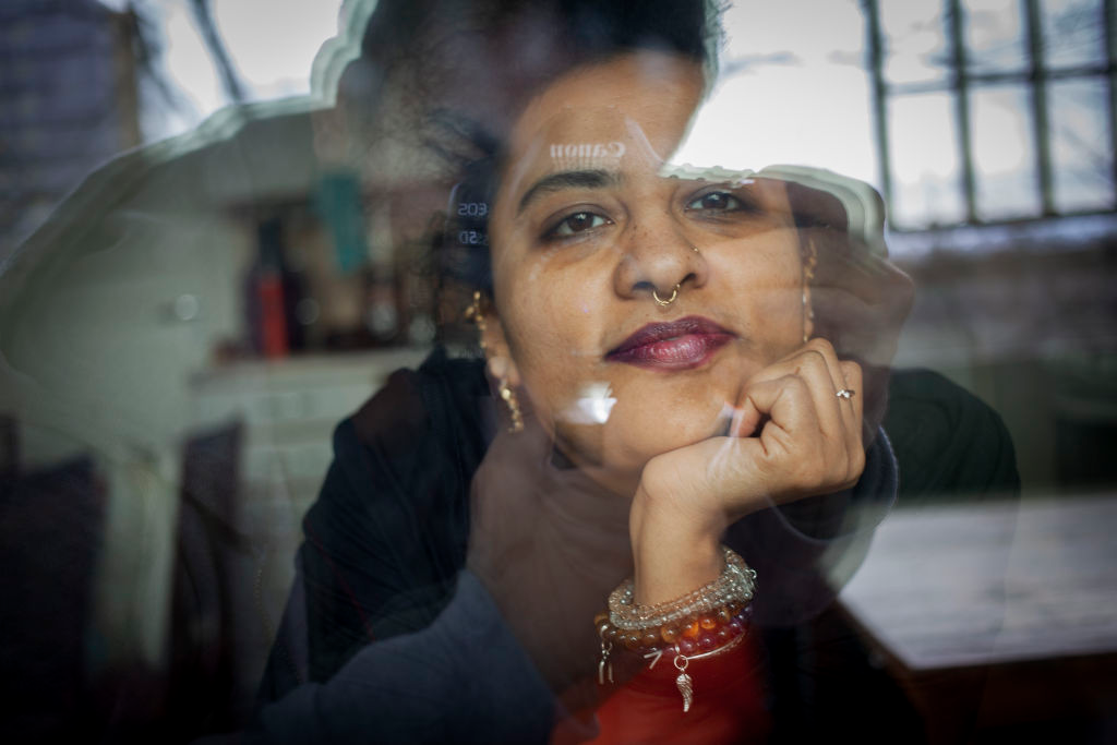 Woman seen through reflective glass