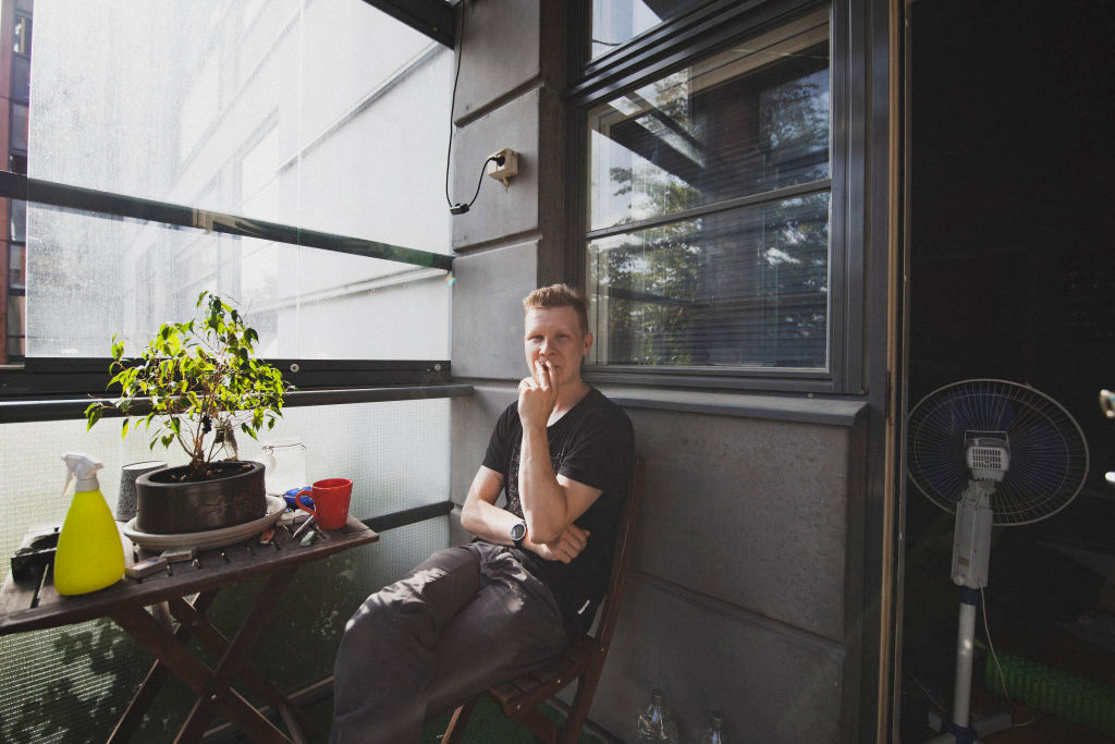 Woman seated beside a window