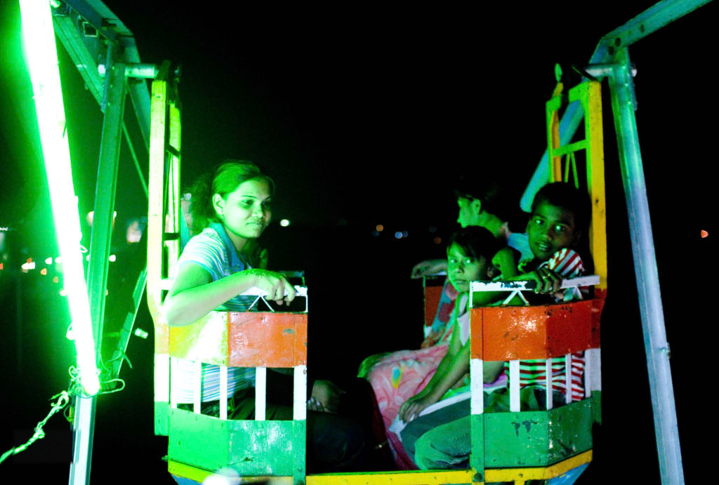 Children on a lit carnival ride