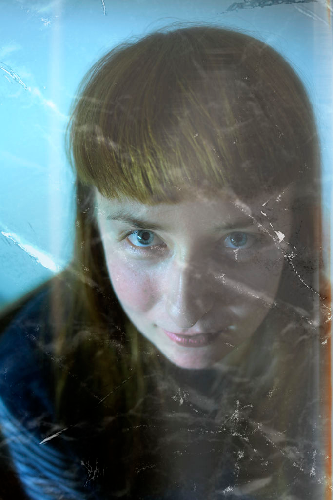 Portrait through blue reflective glass